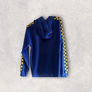 navy blue hoodie with yellow checkered pattern on sleeves.